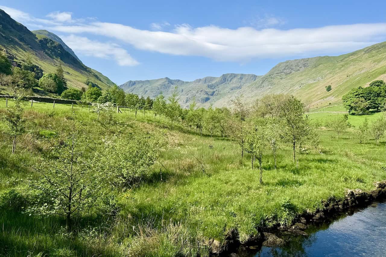 The view south-west from the bridge crossing Grisedale Beck near Thornhow reveals the scenic Grisedale valley, framed by the imposing Dollywaggon Pike and High Crag.