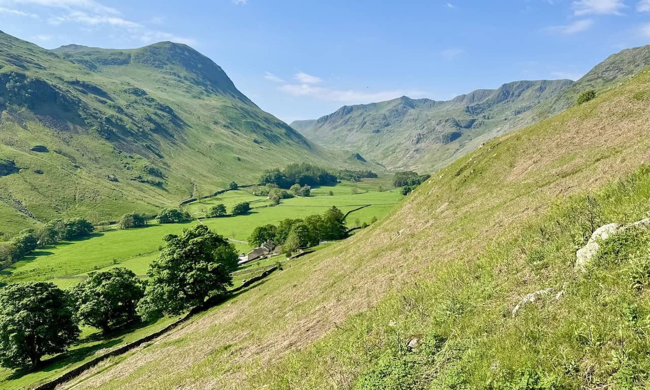 As we ascend the southern slopes of Birkhouse Moor, a stunning panorama of the Grisedale valley unfolds. Dollywaggon Pike dominates the valley’s head, while St Sunday Crag stands majestically to the left. This ascent is part of the rewarding Helvellyn via Striding Edge journey.
