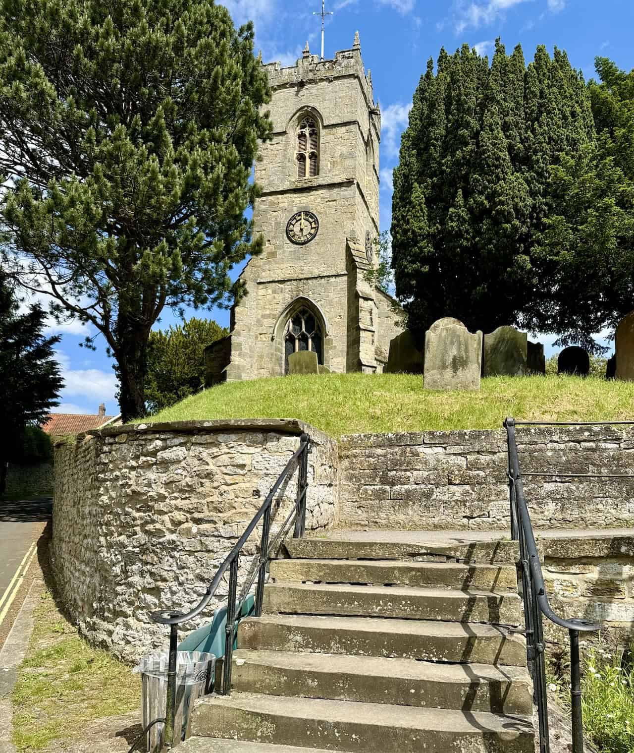 All Saints Church in Thornton-le-Dale stands prominently on a hill beside the A170 Pickering to Scarborough road, overlooking the picturesque village.