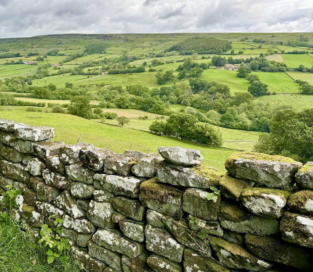 Scenic views of Farndale valley between Park Farm and Cross Farm, with scattered farms and green fields.

