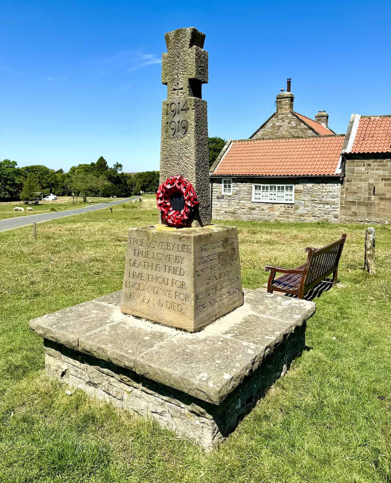 Final photo of the World War I memorial cross on the village green after lunch.