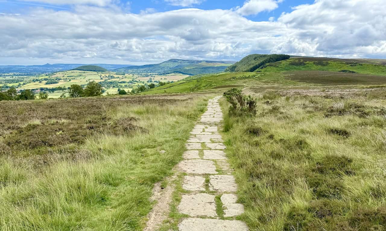 This is the very easy-going stone-paved track across Scarth Wood Moor. It’s a pleasure to walk along, its elevated position affording great views ahead towards the Cleveland Hills, making it an enjoyable part of this awesome Osmotherley walk.