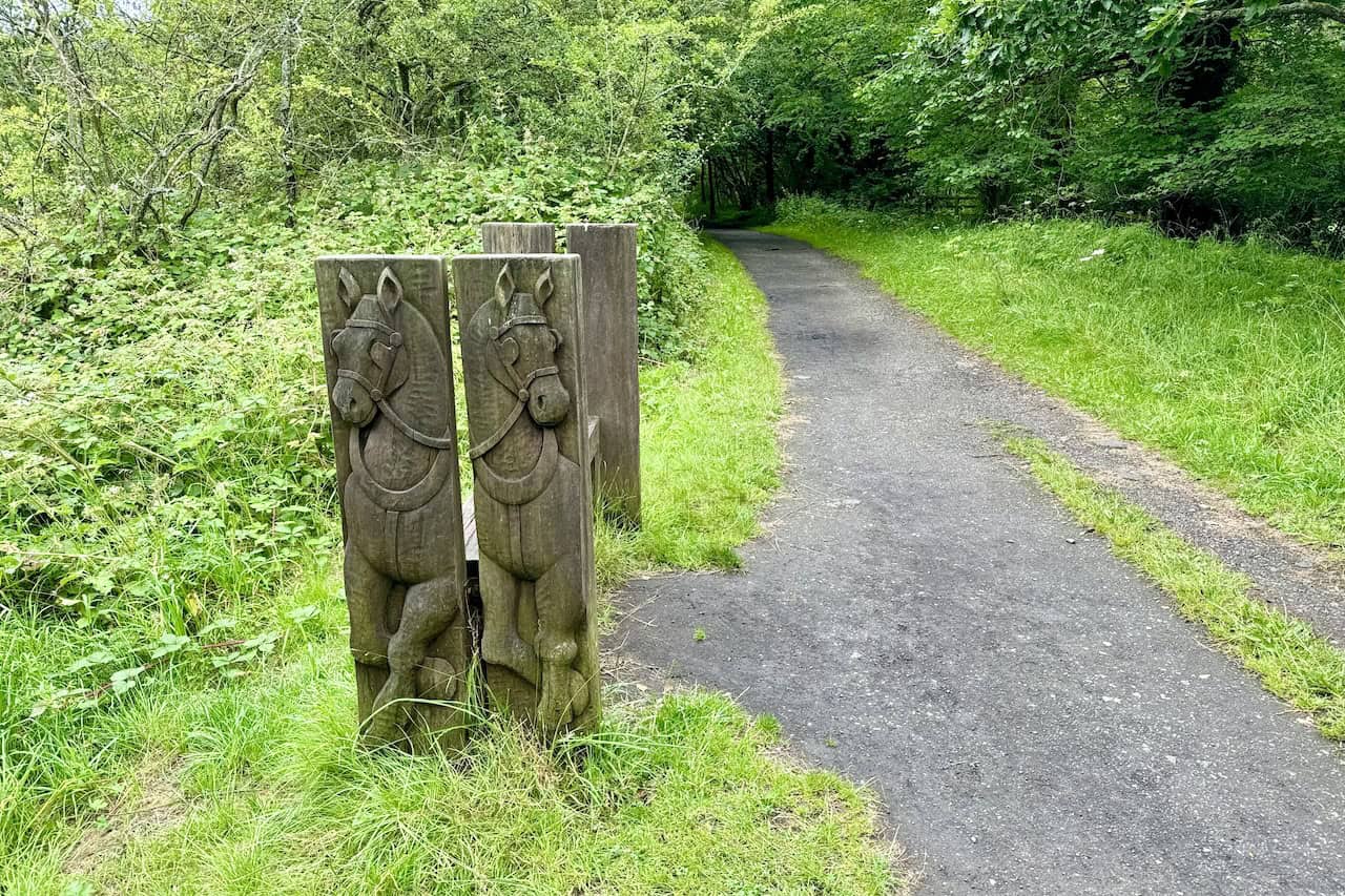 A bench depicting a Victorian couple riding along the old railway line on a coach pulled by two horses. A delightful spot to rest and enjoy a coffee.