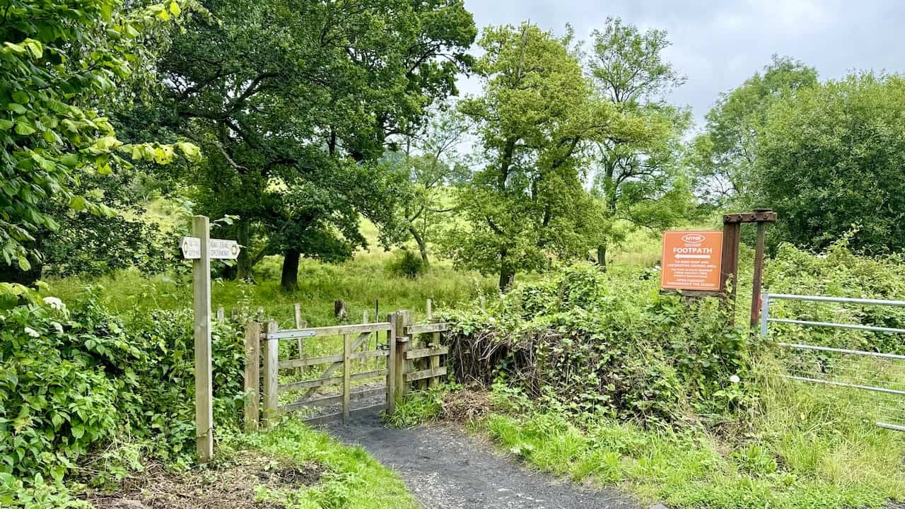 Gate along the Rail Trail, appearing to block the way but leading off to the left, signposted Rail Trail Grosmont. The path is straightforward and easy to navigate.