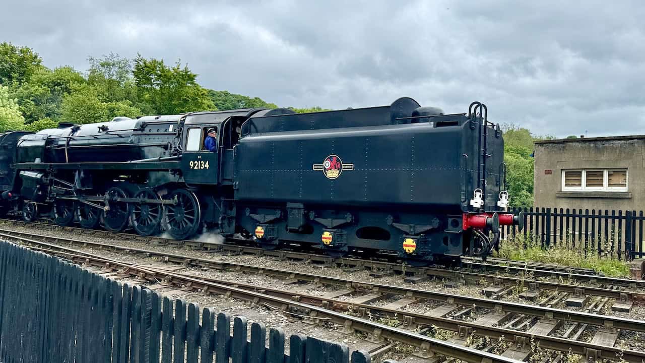 Steam locomotive passing by near Grosmont railway station. This iconic scene is a highlight on the Goathland to Grosmont walk.