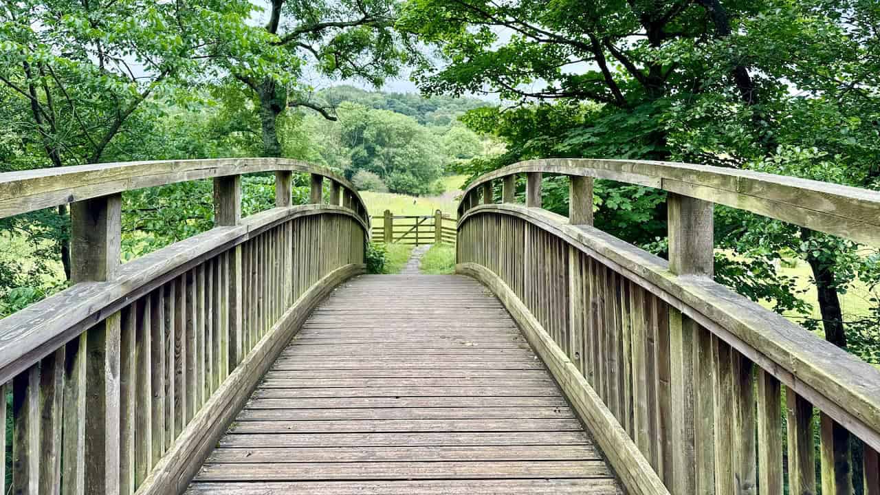 A charming wooden bridge crossing the Murk Esk river, near the railway cottages on the Grosmont to Goathland walk.