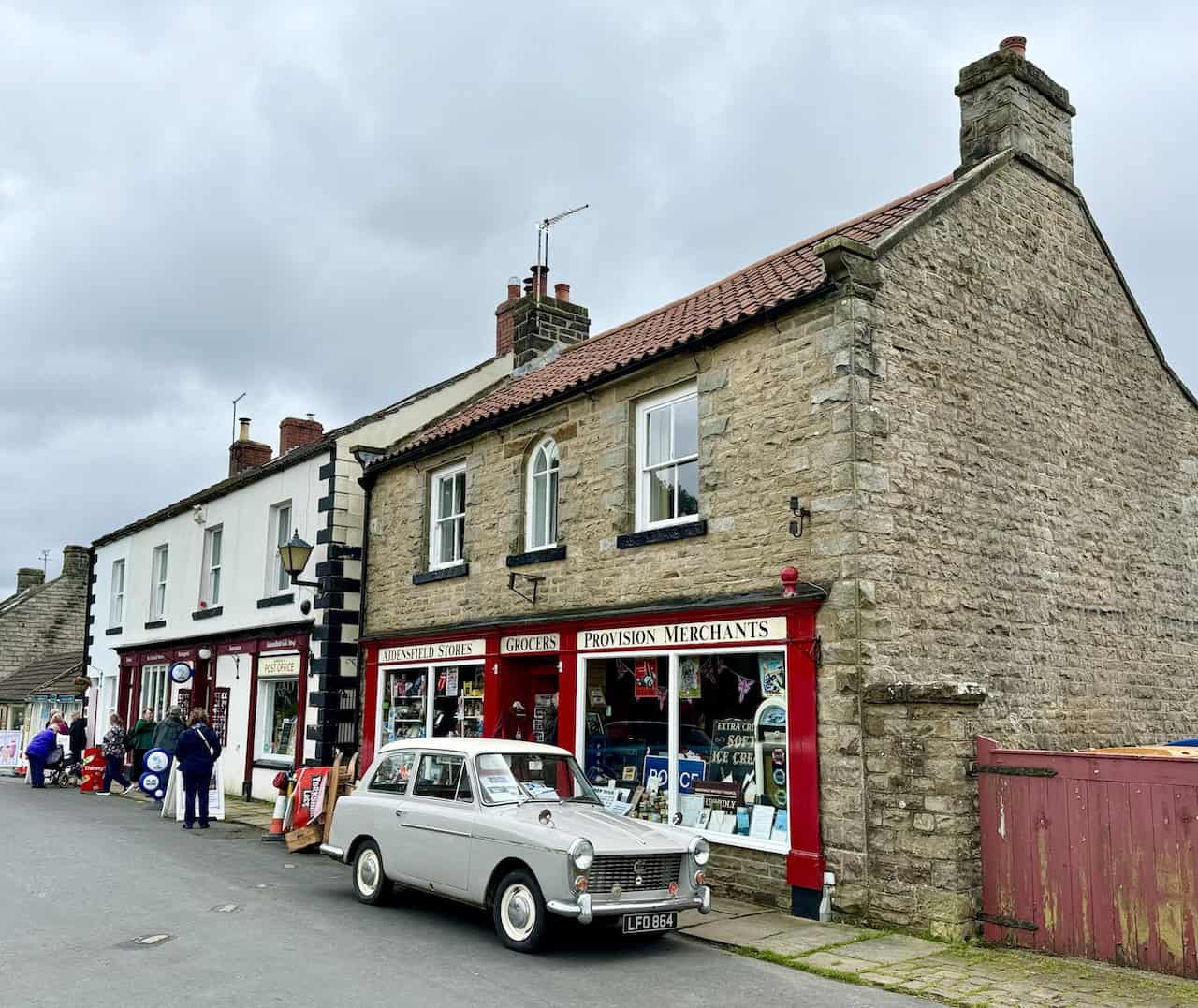 Aidensfield Stores, a notable Heartbeat filming location with a red and cream exterior, seen on the Grosmont to Goathland walk.