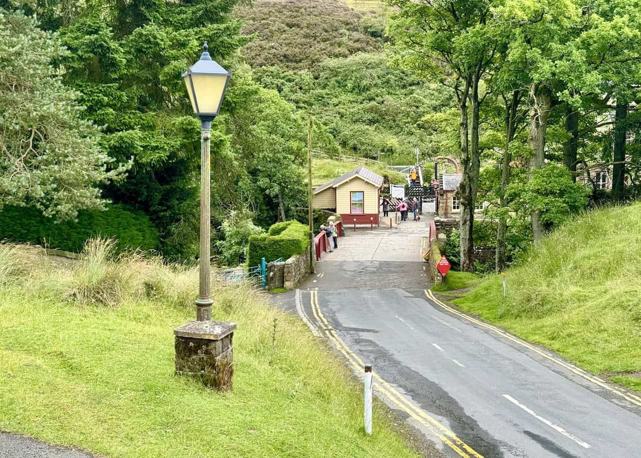 The road and path leading down to Goathland Railway Station, crossing Eller Beck, seen on the Grosmont to Goathland walk.