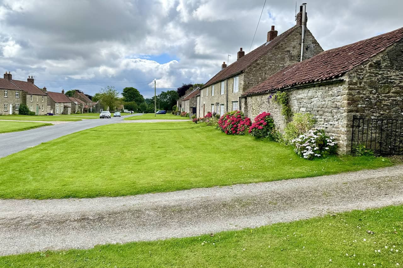 Traditional stone cottages with neatly kept lawns in the picturesque North Yorkshire village of Levisham, part of my Hole of Horcum circular walk.