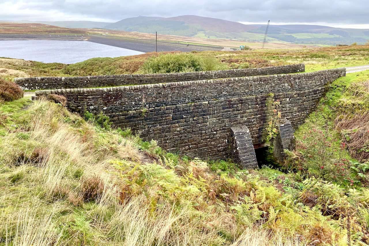 Bridge crossing Near Long Gill with Lower Barden Reservoir visible in the background.