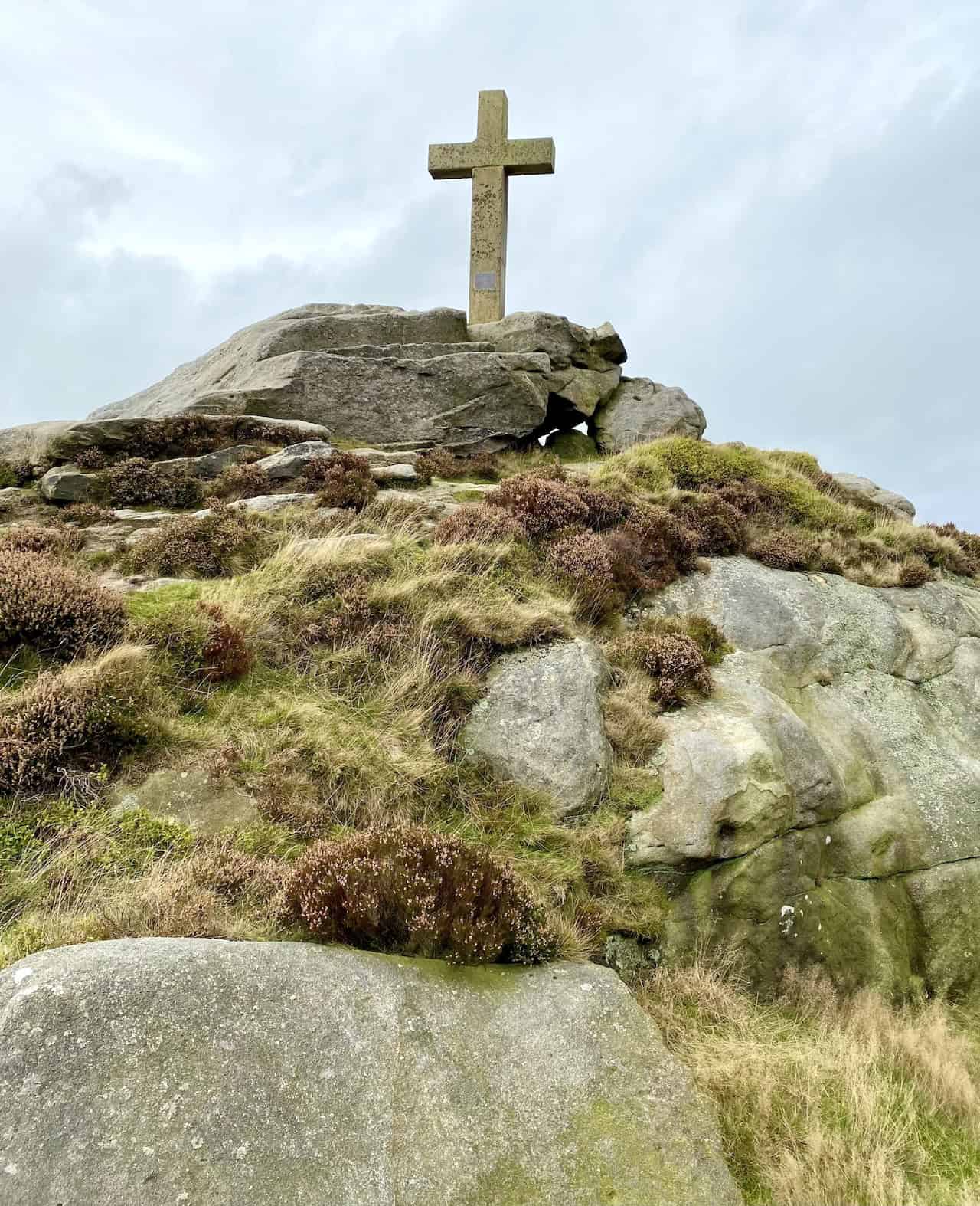 Rylstone Cross at the southern end of the impressive gritstone ridge, with a serene and awe-inspiring landscape view.