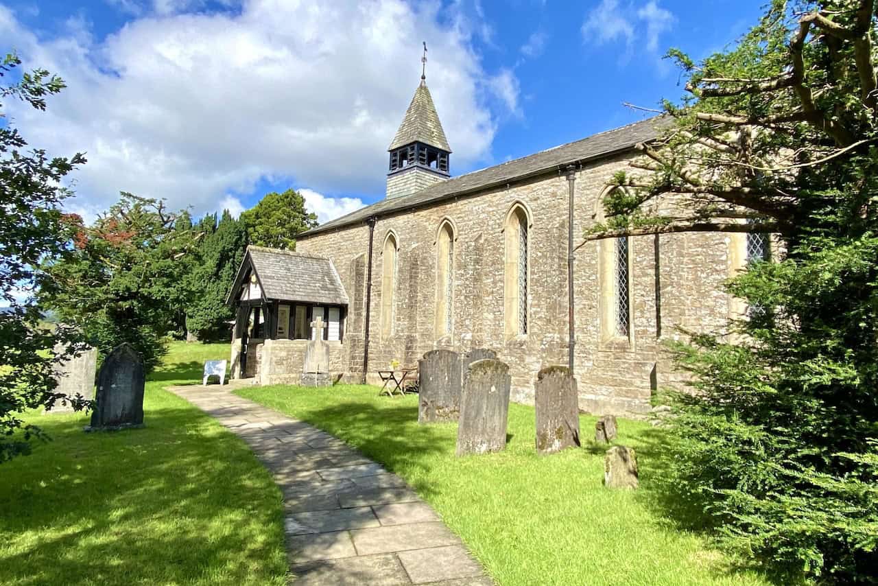 The Grade II listed St John the Evangelist Church in Cowgill, with a welcoming bench for walkers to rest and enjoy a coffee break.