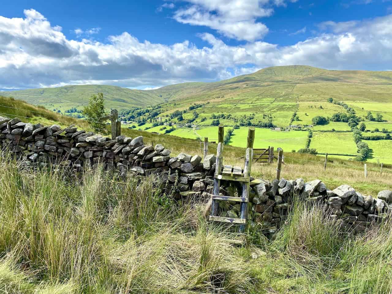 A scenic view looking south-west across Deepdale towards Great Coum, showcasing the rugged beauty of the area.