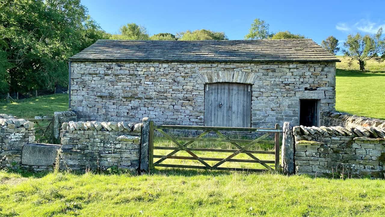 High Ground Farmstead in Flinter Gill ravine, featuring a barn with a collection of period farm machinery and implements, a highlight of the Great Coum walk.