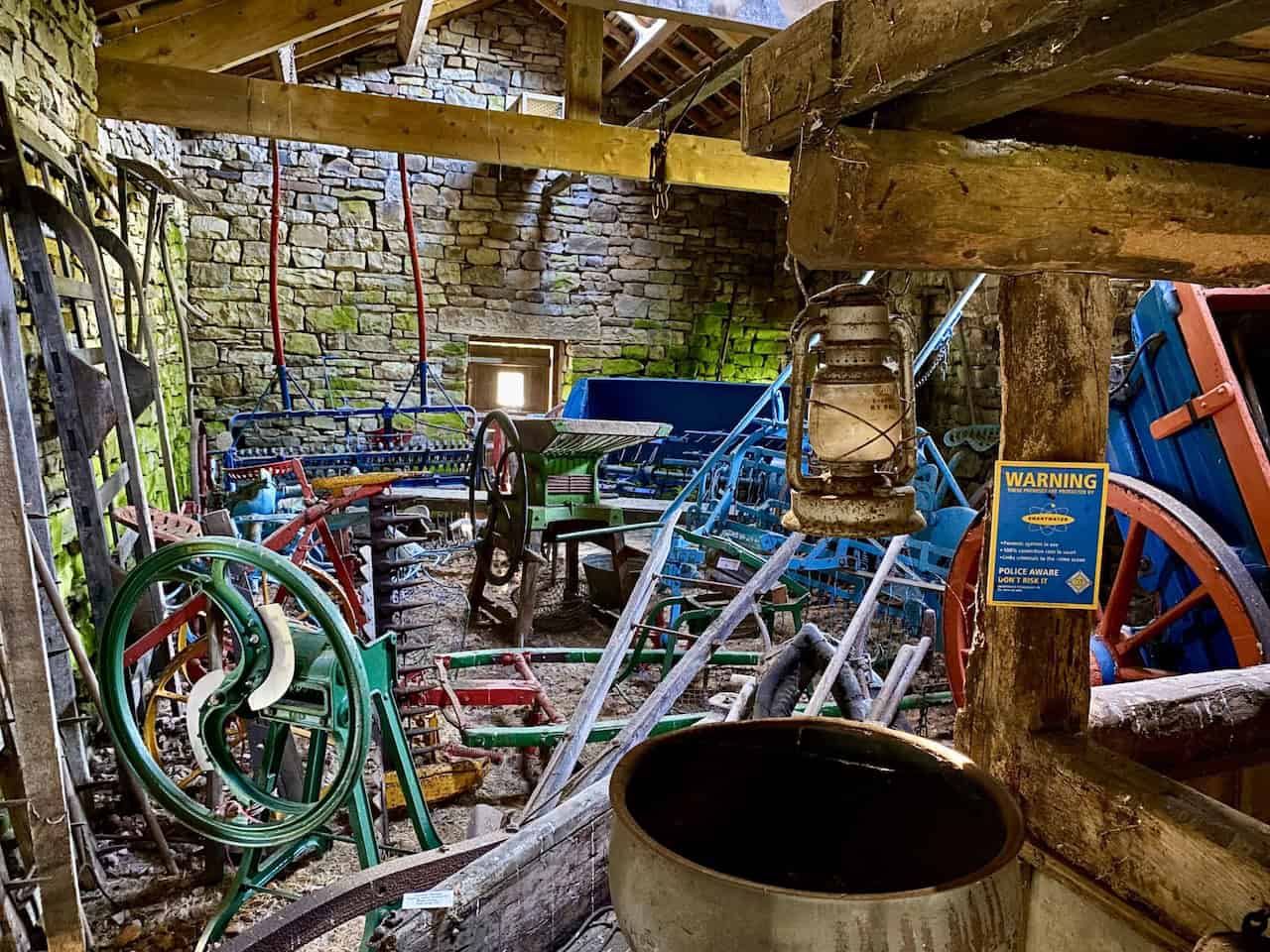 High Ground Farmstead in Flinter Gill ravine, featuring a barn with a collection of period farm machinery and implements, a highlight of the Great Coum walk.