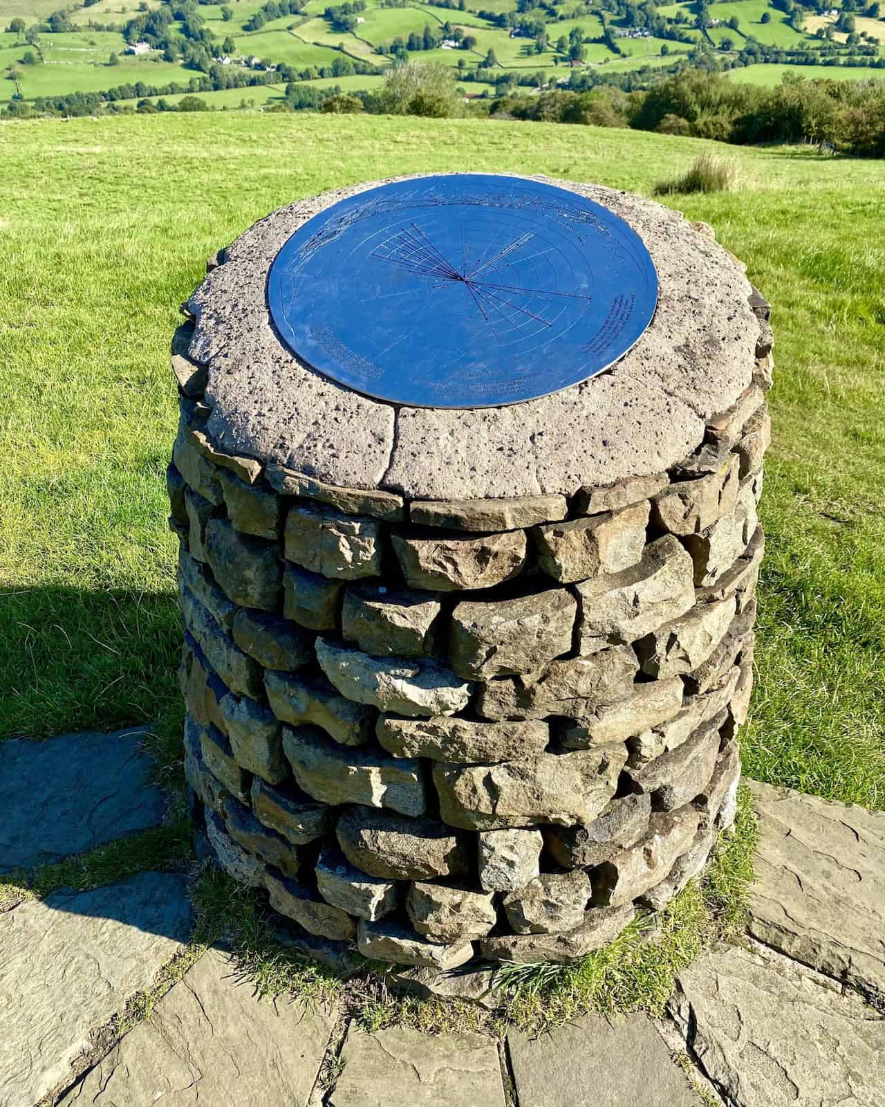 A toposcope at the top of Flinter Gill ravine, offering panoramic views of the surrounding landscape, including peaks in the Howgill Fells.