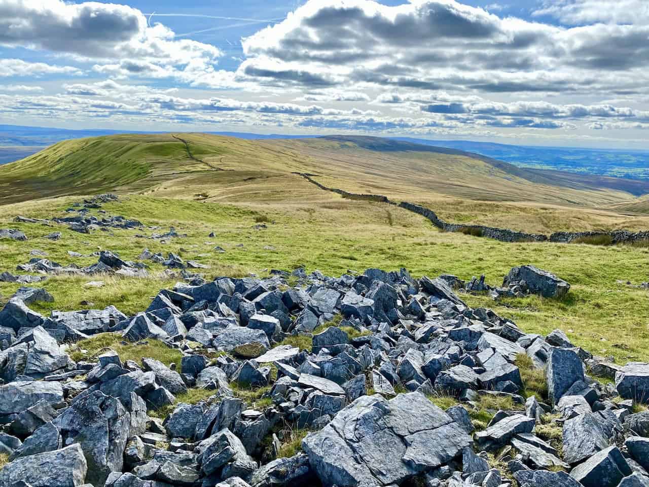 The boulder-strewn area of Gatty Pike with Gragareth in the background, reached by following the route south from Great Coum.