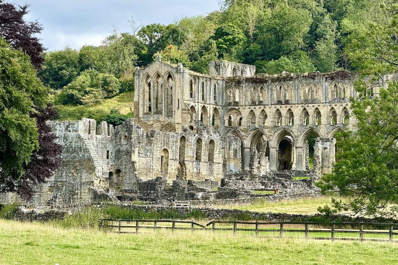 A close-up of Rievaulx Abbey, highlighting its intricate stonework and arched windows.
