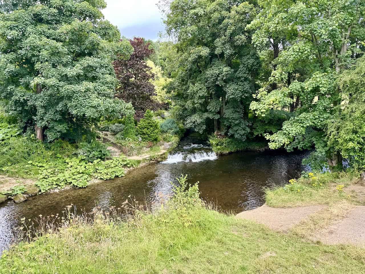 A small stream joining the River Rye at Rievaulx Bridge, seen after exploring the village of Rievaulx during the Helmsley to Rievaulx Abbey walk.
