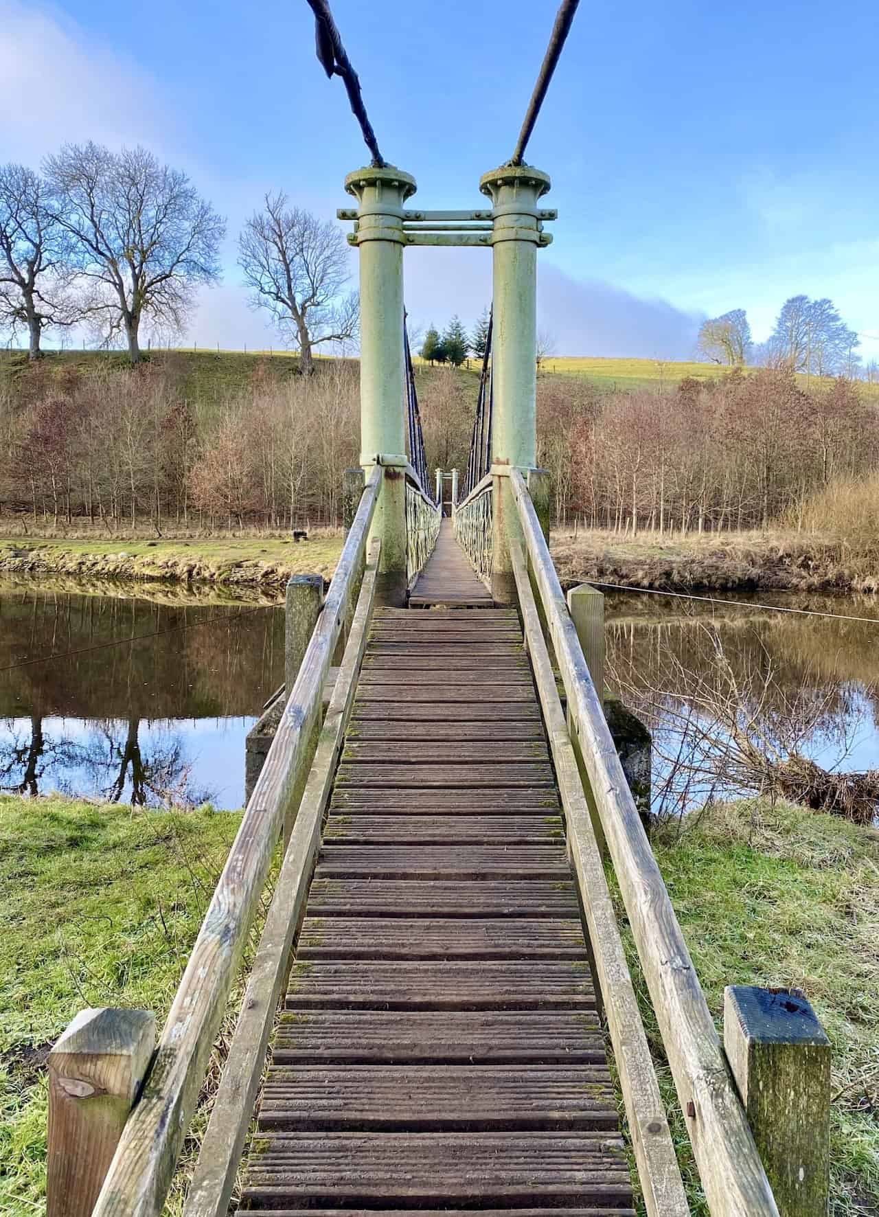 Hebden Suspension Bridge, a historic footbridge built in 1884, providing a scenic crossing over the River Wharfe. 