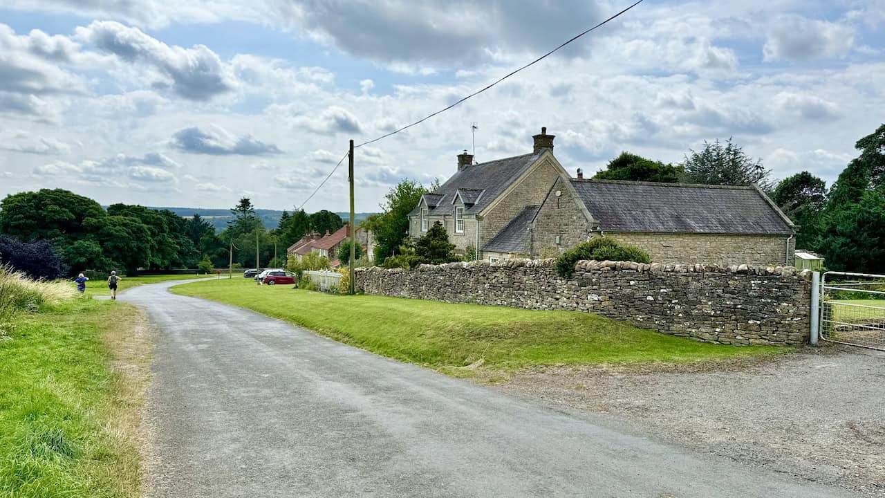 Minor road Clavery Ley Lane leading into Old Byland, a charming spot for lunch with a handy bench.
