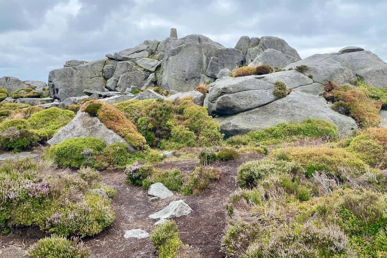 Our trek reaches Simon’s Seat. This striking outcrop of millstone grit rewards us with spectacular views of Wharfedale and beyond, marking the halfway point of our Simon's Seat walk.