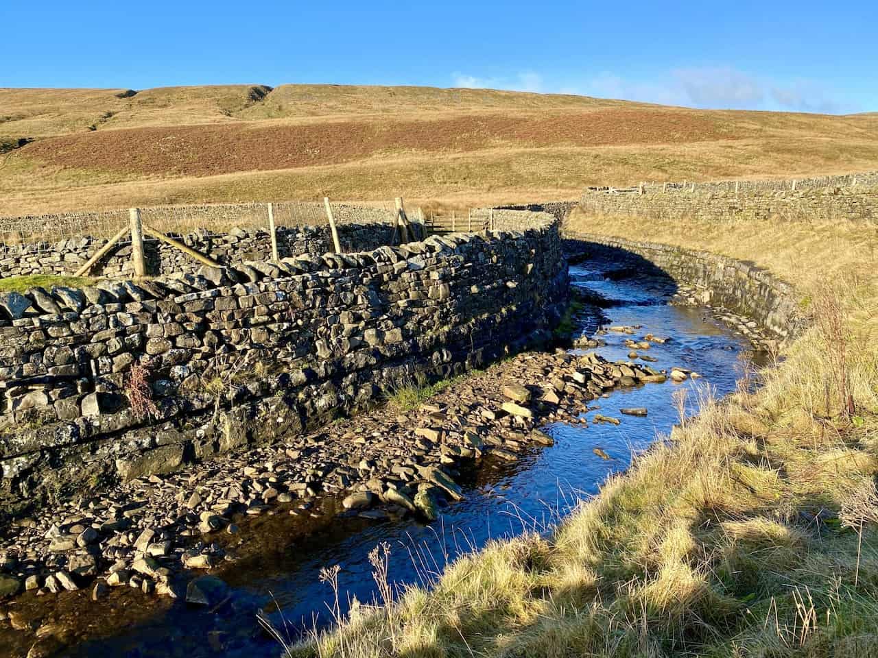 Aqueduct in Little Dale, carrying water from Force Gill over the Settle to Carlisle railway line, seen during the Whernside circular walk.