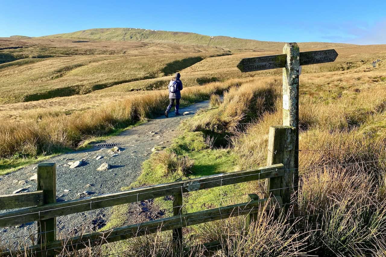 Path leading up to Whernside after crossing a stile, part of the Whernside circular walk.