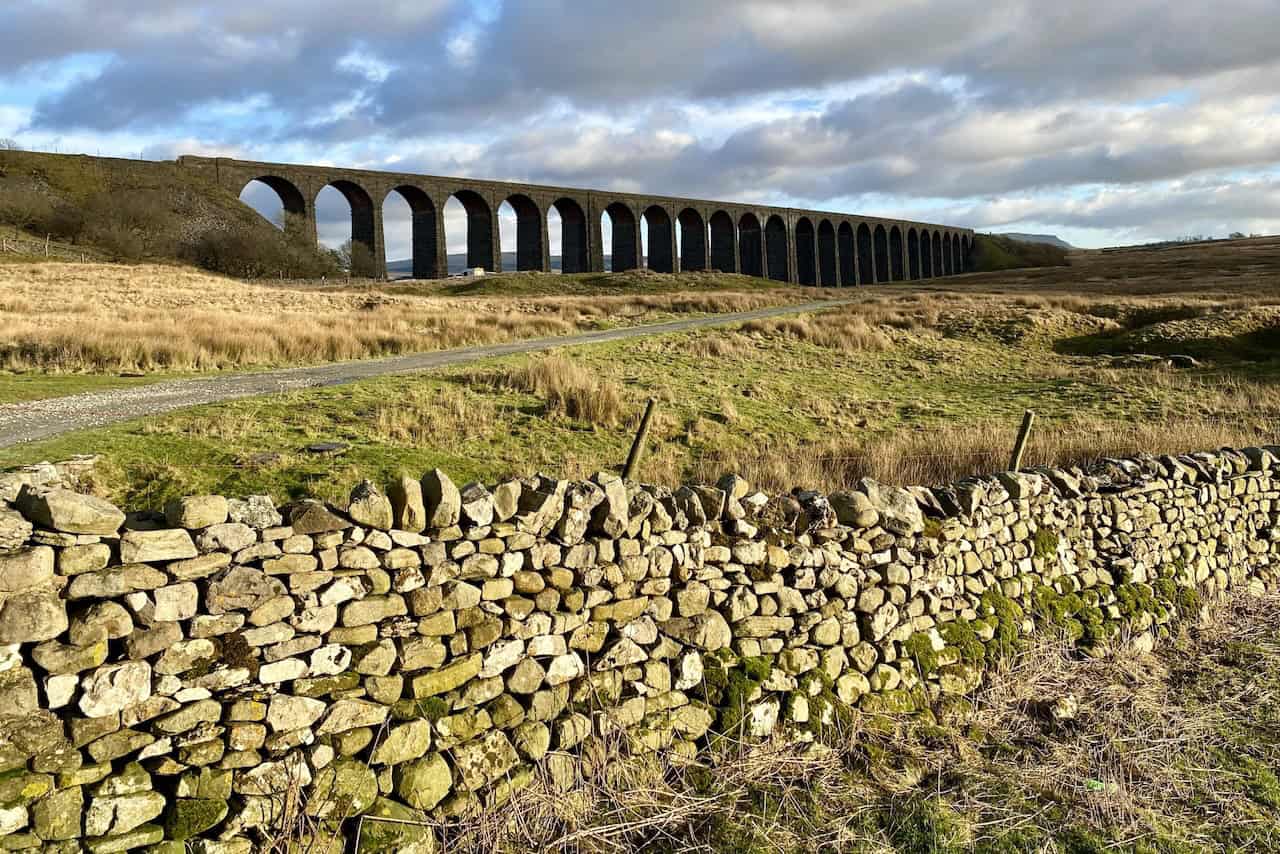 Approaching Ribblehead Viaduct from Gunnerfleet Farm, showcasing one of its 24 arches during the Whernside circular walk.