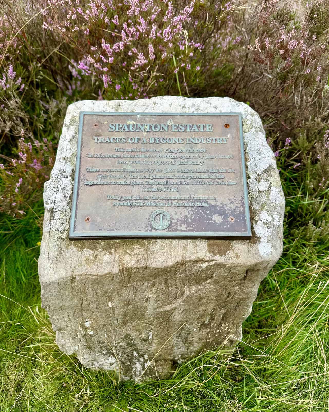 Marker stone with a plaque titled ‘Spaunton Estate – Traces of a Bygone Industry’ near Scugdale.
