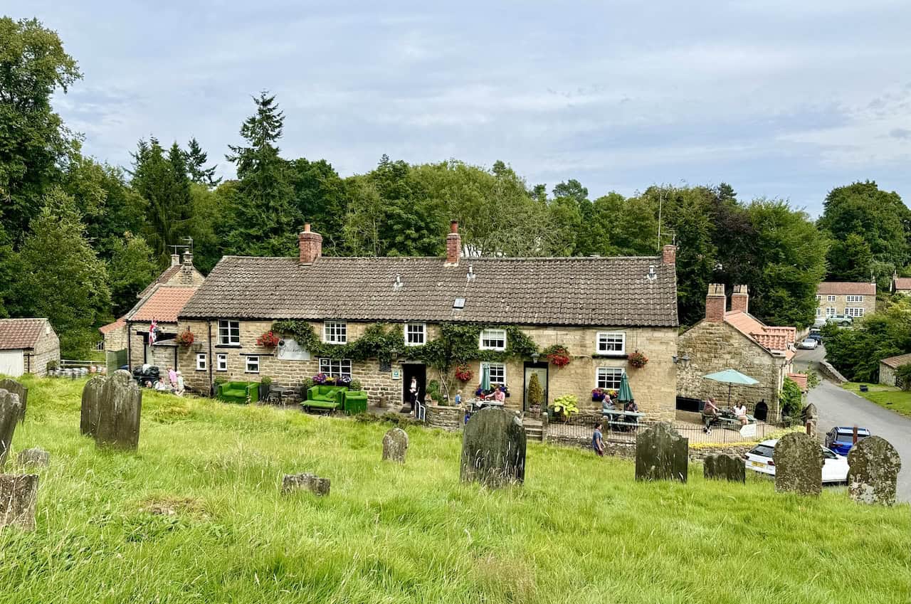 Graveyard of the Church of St Mary with views of The Blacksmiths Arms and Lastingham village.
